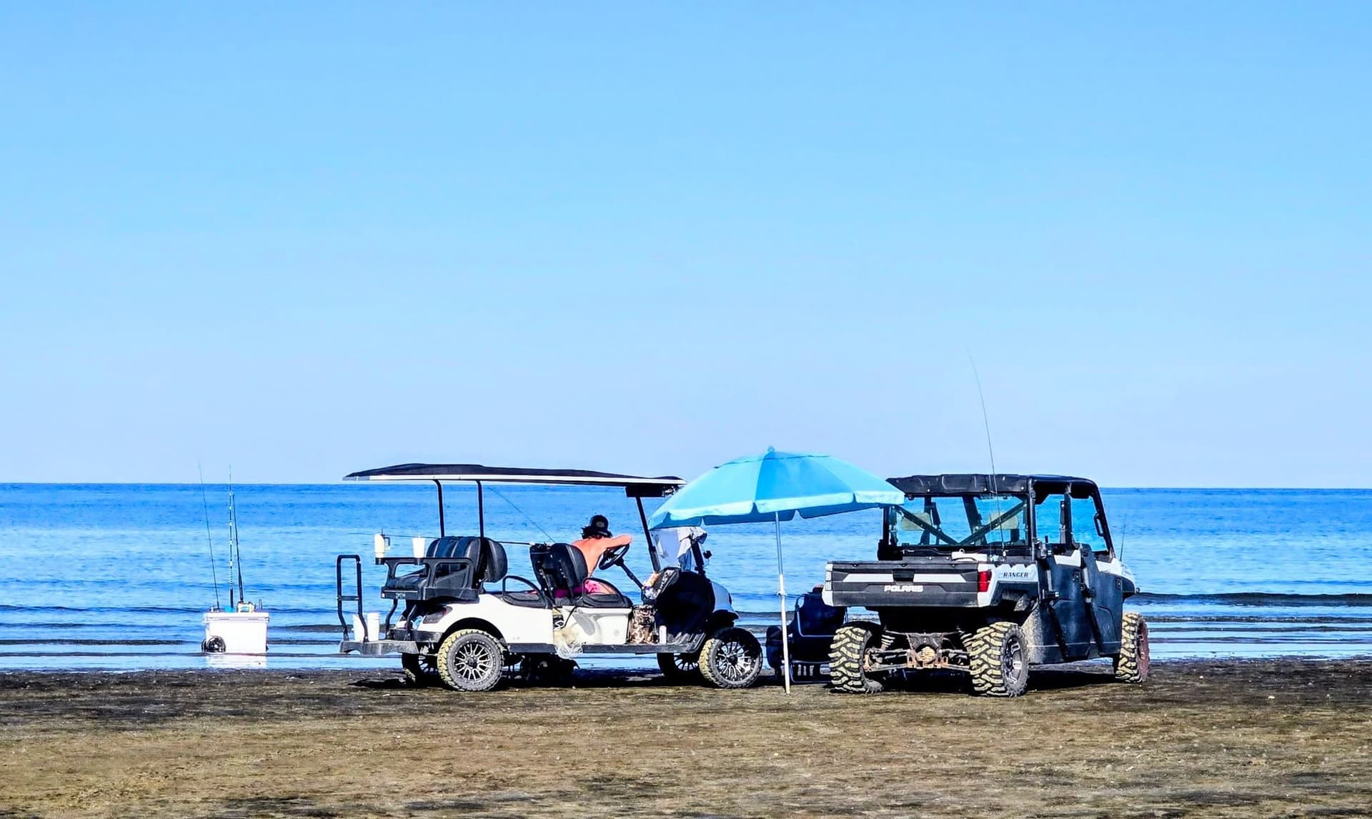 Golf carts on the beach in Grand Isle, LA near Blue Dolphin Inn & Cottages
