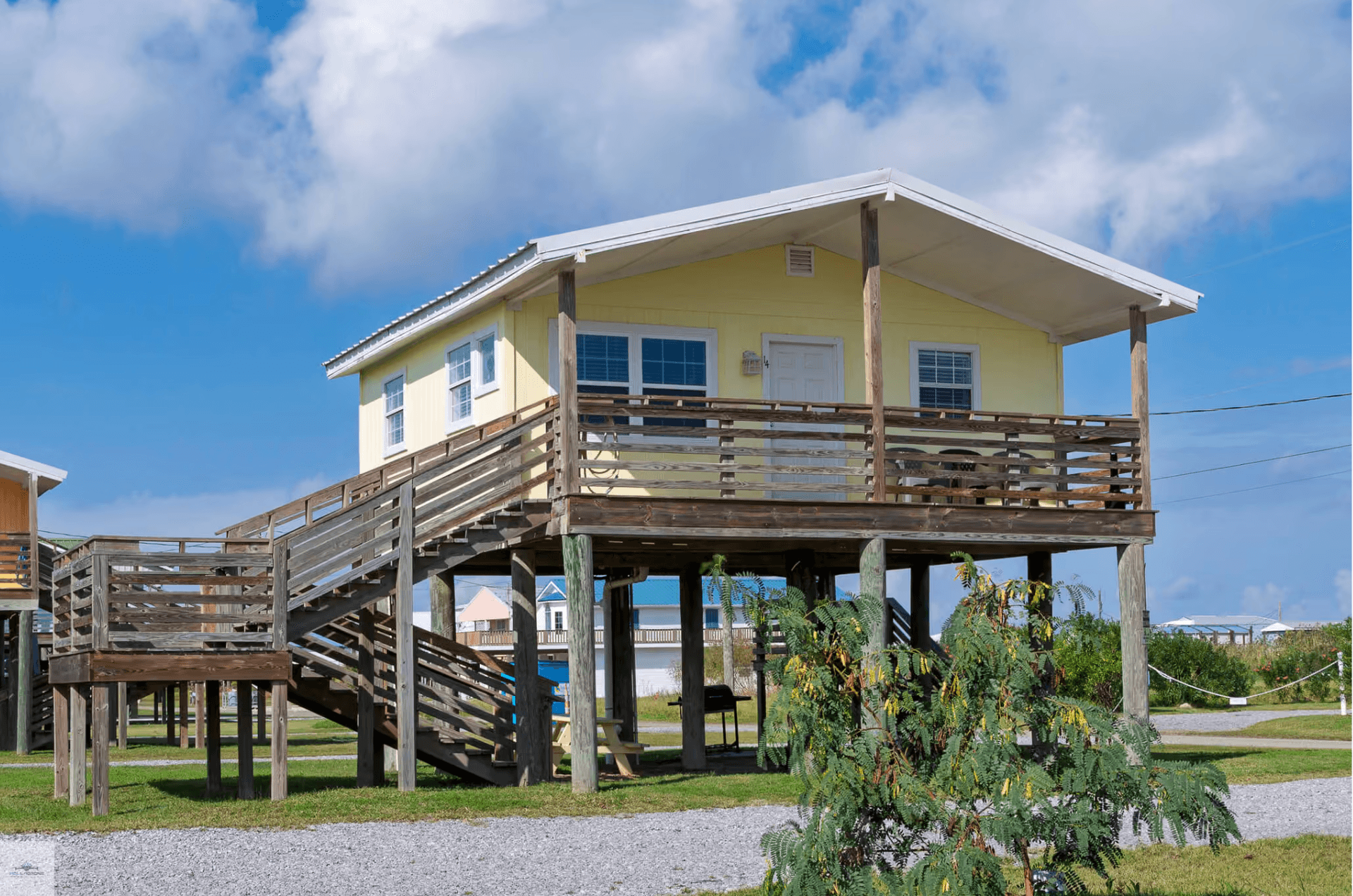 Yellow beach cottage on stilts at Blue Dolphin Inn & Cottages in Grand Isle, Louisiana
